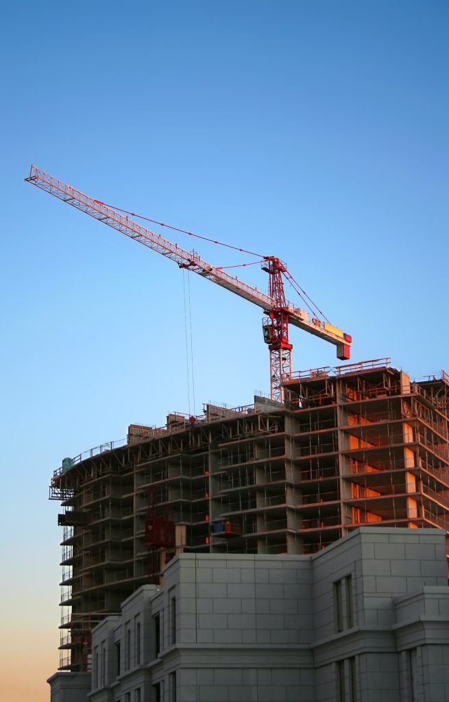 A crane on top of a partially built building